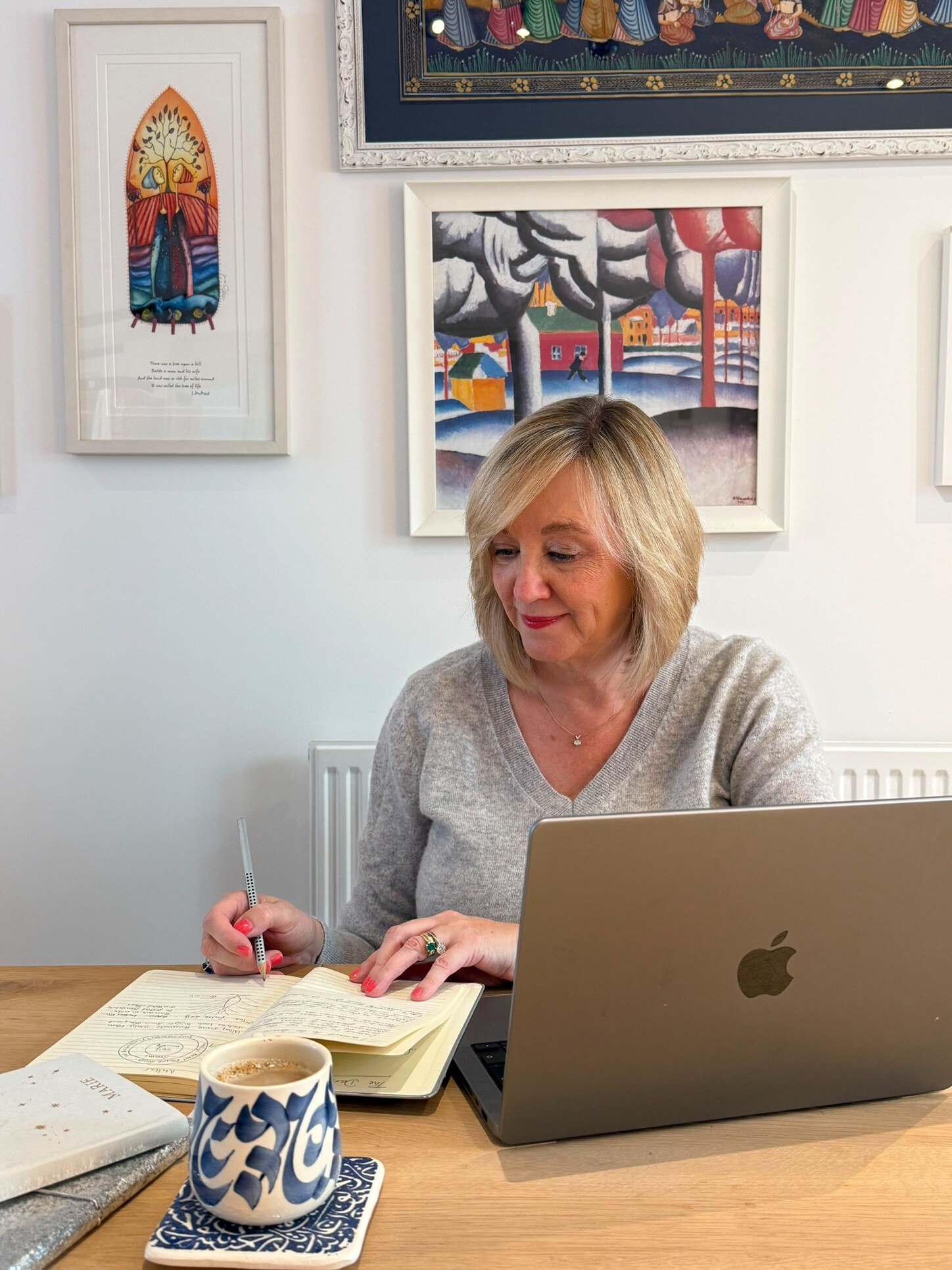 Marie at her desk in a reflective moment