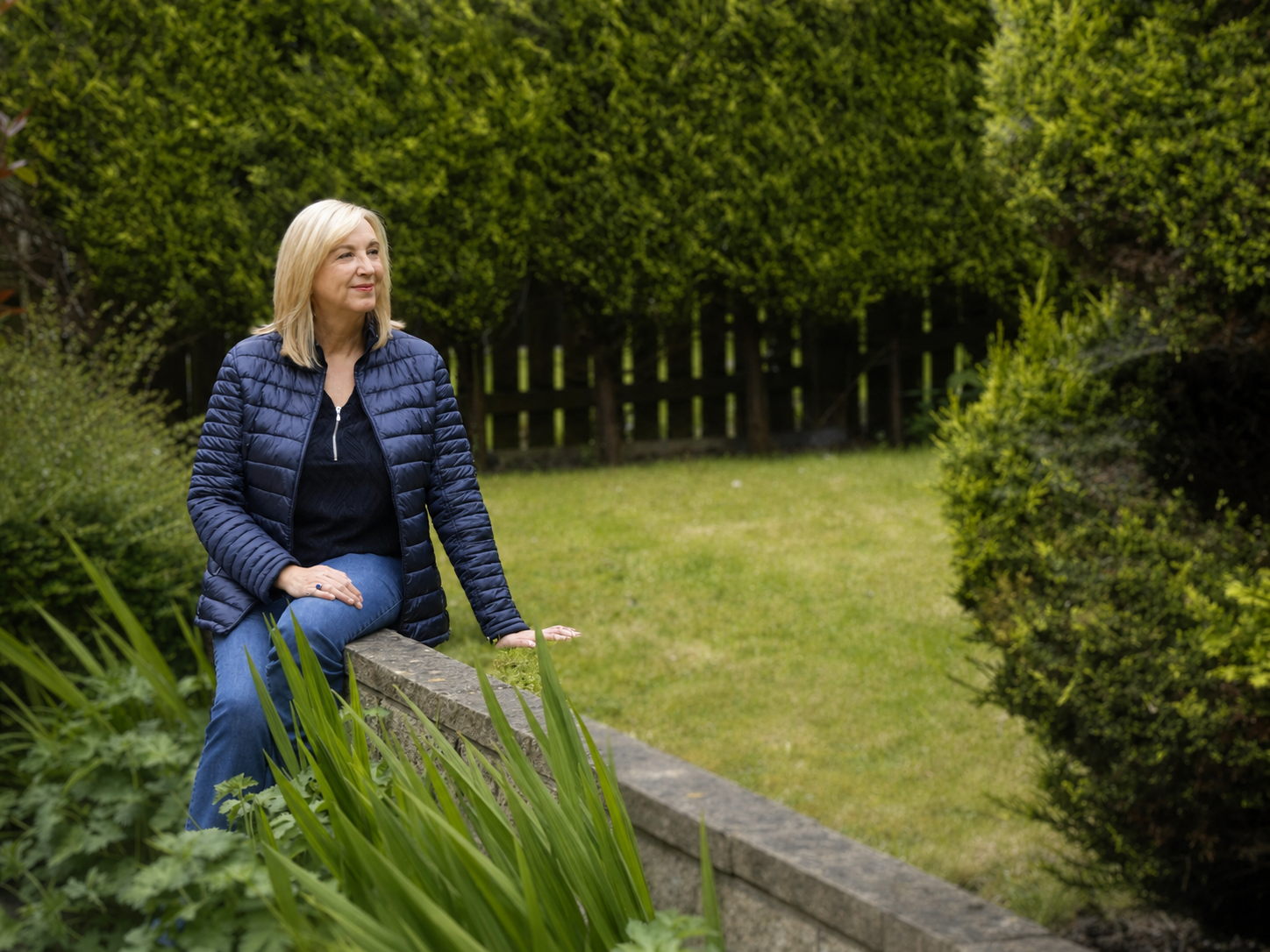 Marie seated in a garden